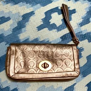 Coach clutch in rose gold logo leather